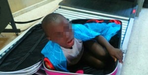 A picture provided by Spanish Guardia Civil on May 8, 2015 shows an 8-year-old sub-Saharan boy hidden in a suitcase. The suitcase was carried by a young woman of 19, which was controlled around noon on May 7, 2105 when she was entering in Ceuta, the Spanish enclave in the north of Morocco. RESTRICTED TO EDITORIAL USE - MANDATORY CREDIT "AFP PHOTO/ HO/ SPANISH GUARDIA CIVIL" NO MARKETING NO ADVERTISING CAMPAIGNS - DISTRIBUTED AS A SERVICE TO CLIENTS - BEST QUALITY AVAILABLE